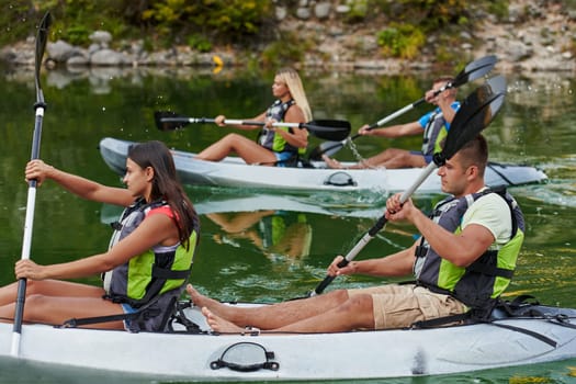 A group of friends enjoying having fun and kayaking while exploring the calm river, surrounding forest and large natural river canyons.