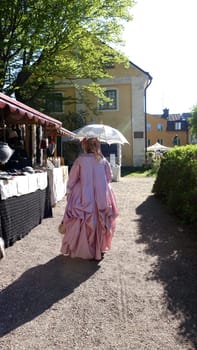 Uppsala, Sweden, May 18, 2024. A day at the Linnaeus Garden Party. 1700s theme. Umbrella.