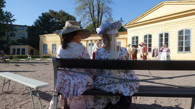 Uppsala, Sweden, May 18, 2024. A day at the Linnaeus Garden Party. 1700s theme. Sitting.