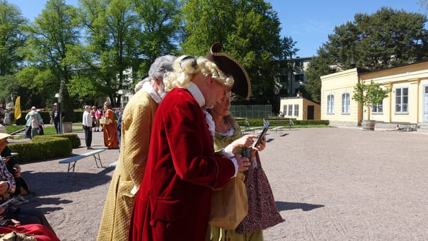 Uppsala, Sweden, May 18, 2024. A day at the Linnaeus Garden Party. 1700s theme. Smartphone.