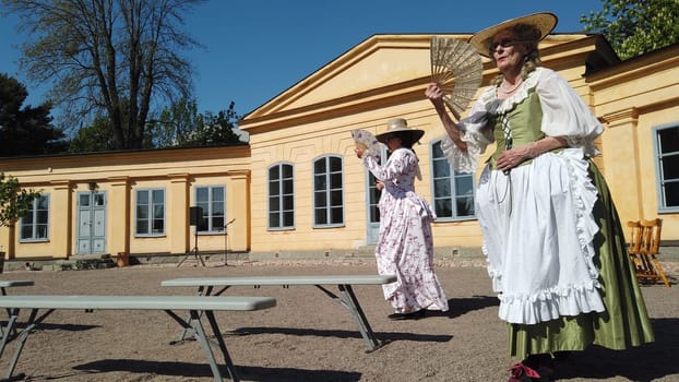 Uppsala, Sweden, May 18, 2024. A day at the Linnaeus Garden Party. 1700s theme. Fan.