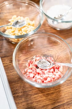 Preparing star-shaped cookies, half-dipped in chocolate, accented with peppermint chocolate chips for the holidays.