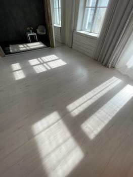 Interior of an empty white and black room with windows