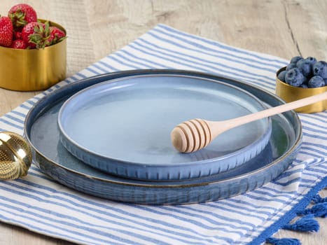 Empty blue ceramic plate on the table, top view