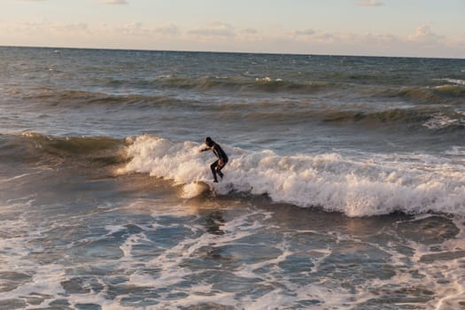 Athletes riding a surfboard on the sea