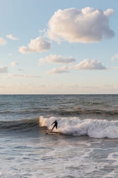 Athletes riding a surfboard on the waves