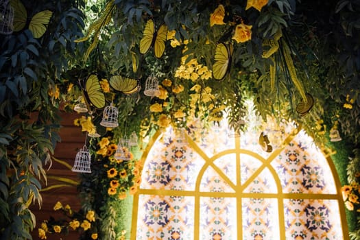 flowers and yellow butterflies by the window with light