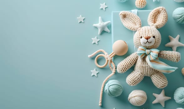 A knitted bunny rabbit sits surrounded by baby toys in a circle on a blue background. The cute stuffed toy is the center of attention, while the toys add a pop of color to the scene