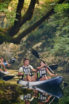 A group of friends enjoying having fun and kayaking while exploring the calm river, surrounding forest and large natural river canyons.