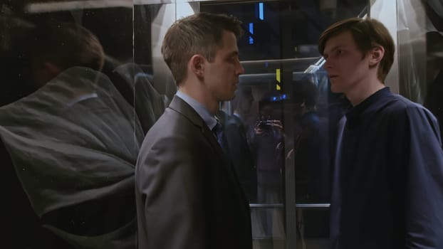 Close up of man listening carefully to the noise of elevator malfunction and pressing the floor button. Stock clip. Men risking to use the faulty elevator