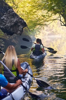 A group of friends enjoying having fun and kayaking while exploring the calm river, surrounding forest and large natural river canyons.