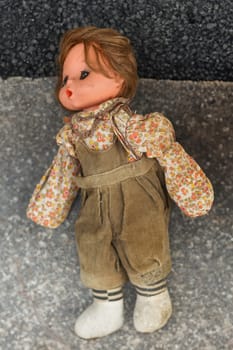 Dirty doll in dust at the flea market in France