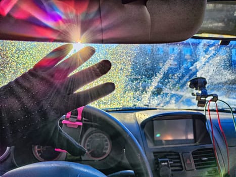 A vehicles windshield is covered with frost, reducing visibility and highlighting the challenges of winter driving