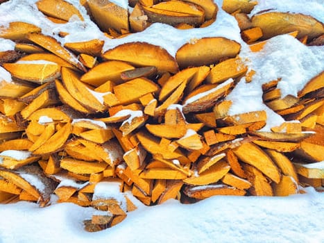 Firewood, boards, woodpile and snow. background, texture, frame, pattern, place for text, space for copying