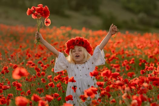 A young girl is standing in a field of red poppies, holding a bouquet of flowers. She is wearing a red hat and a white dress. Concept of joy and innocence