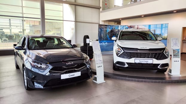 Cheboksary, Russia - April 05, 2023: Cars in showroom of dealership KIA. Re-export to Russia