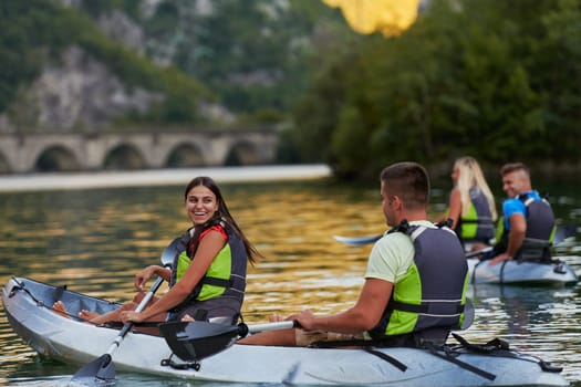 A group of friends enjoying having fun and kayaking while exploring the calm river, surrounding forest and large natural river canyons.