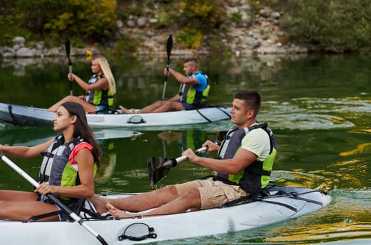 A group of friends enjoying having fun and kayaking while exploring the calm river, surrounding forest and large natural river canyons.