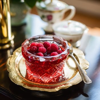 Raspberry jam and raspberries in a crystal bowl, country food and English recipe idea for menu, food blog and cookbook inspiration