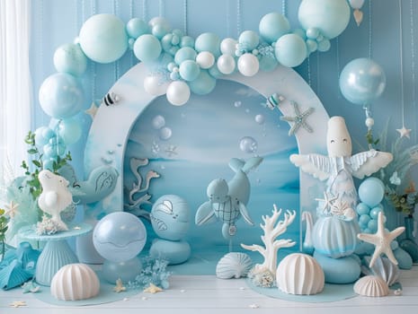 A blue and white room with a blue archway and a blue background. The archway is filled with balloons and there are several stuffed animals, including a whale and a dolphin