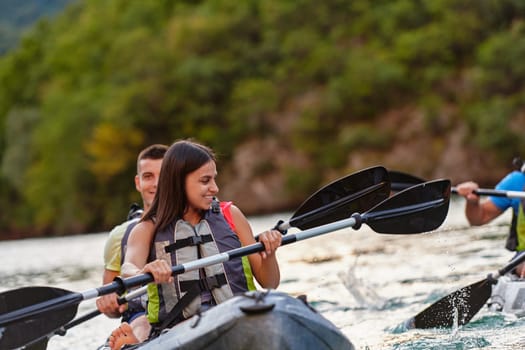 A young couple enjoying an idyllic kayak ride in the middle of a beautiful river surrounded by forest greenery.