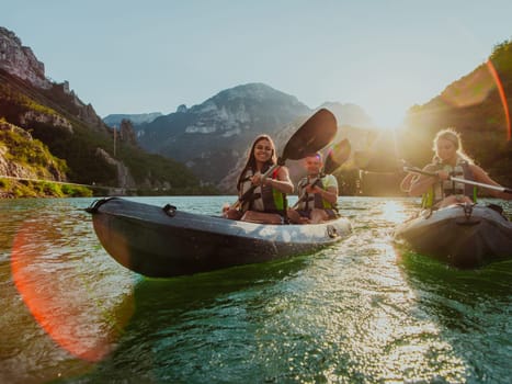 A group of friends enjoying fun and kayaking exploring the calm river, surrounding forest and large natural river canyons during an idyllic sunset