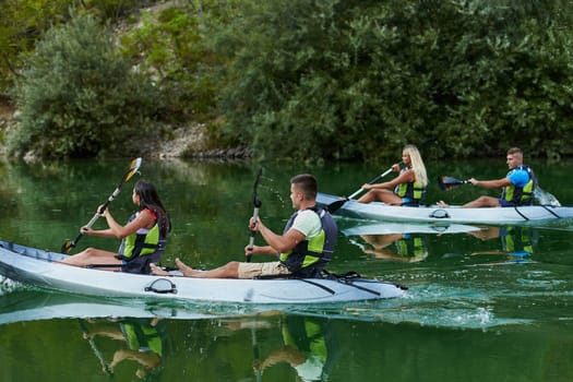 A group of friends enjoying having fun and kayaking while exploring the calm river, surrounding forest and large natural river canyons.