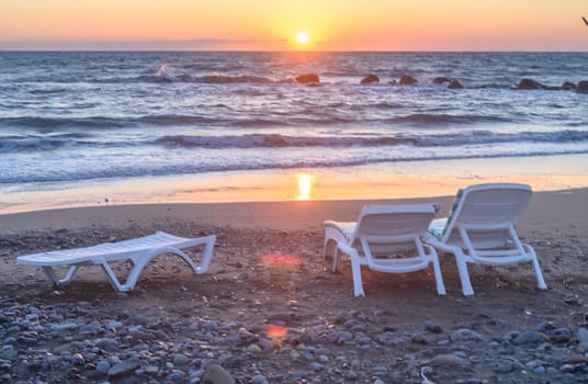 sun loungers on the beach of the Mediterranean sea at sunset 3