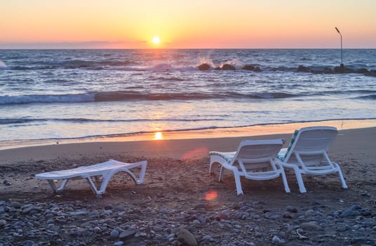 sun loungers on the beach of the Mediterranean sea at sunset 2