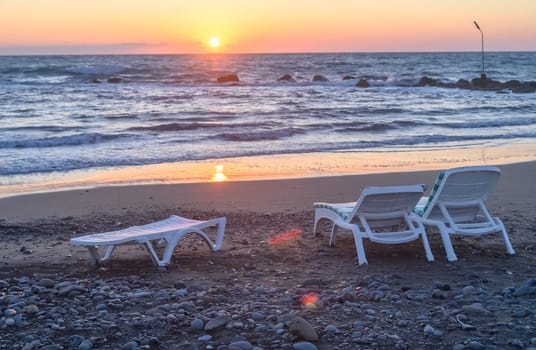 Sun loungers stand on the shore near the Mediterranean Sea