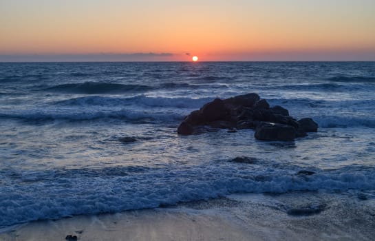 waves of the sea break on the rocks. Mediterranean Sea near the small Village