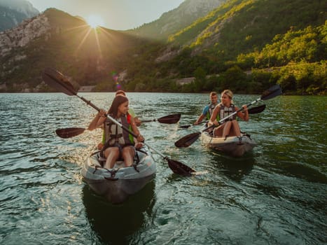 A group of friends enjoying fun and kayaking exploring the calm river, surrounding forest and large natural river canyons during an idyllic sunset