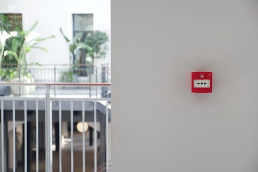 Red fire alarm button on wall