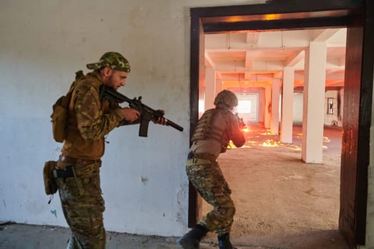 A group of professional soldiers bravely executes a dangerous rescue mission, surrounded by fire in a perilous building