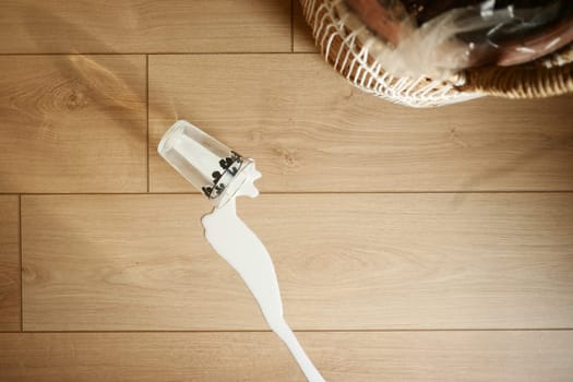 Spilled white milk on a wooden floor