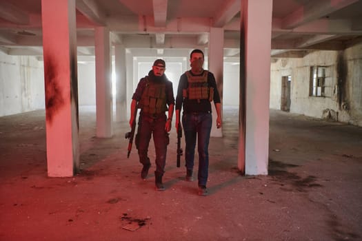 An abandoned building serves as the stronghold for a team of terrorists, fiercely guarding their occupied territory with guns and military equipment.