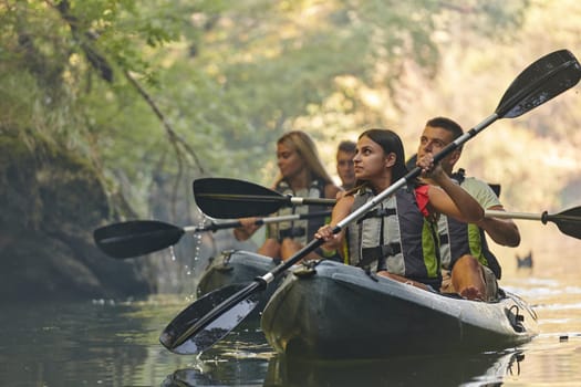 A group of friends enjoying having fun and kayaking while exploring the calm river, surrounding forest and large natural river canyons.