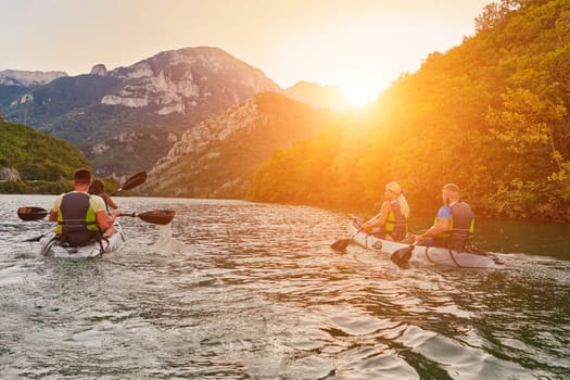 A group of friends enjoying fun and kayaking exploring the calm river, surrounding forest and large natural river canyons during an idyllic sunset