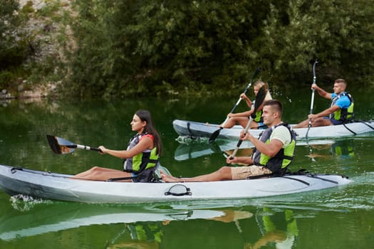 A group of friends enjoying having fun and kayaking while exploring the calm river, surrounding forest and large natural river canyons.