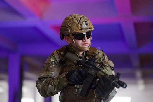 A professional soldier undertakes a perilous mission in an abandoned building illuminated by neon blue and purple lights.