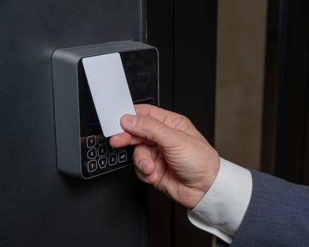 A man opens the door with a card. Modern electronic lock. Keyless Entry.