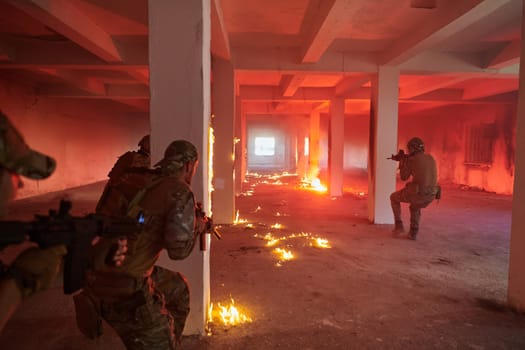 A group of professional soldiers bravely executes a dangerous rescue mission, surrounded by fire in a perilous building