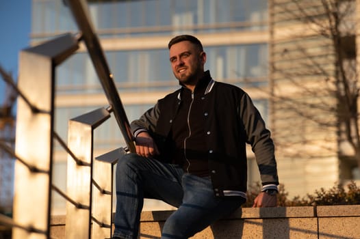 Portrait of a smiling bearded man outdoors at sunset