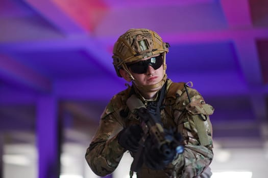 A professional soldier undertakes a perilous mission in an abandoned building illuminated by neon blue and purple lights.