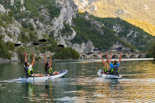 A group of friends enjoying having fun and kayaking while exploring the calm river, surrounding forest and large natural river canyons.