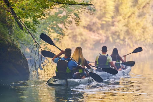 A group of friends enjoying having fun and kayaking while exploring the calm river, surrounding forest and large natural river canyons.