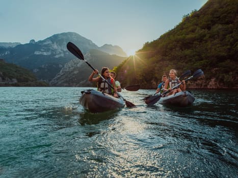 A group of friends enjoying fun and kayaking exploring the calm river, surrounding forest and large natural river canyons during an idyllic sunset