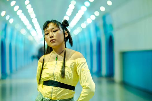 Portrait of an Asian young woman in a subway crossing