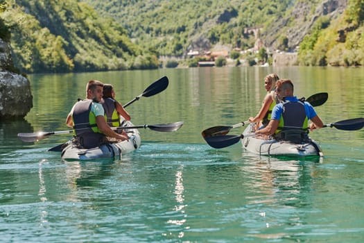 A group of friends enjoying having fun and kayaking while exploring the calm river, surrounding forest and large natural river canyons.