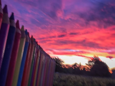 A beautiful image of a school wall in coloured pencils against a blushing evening sky, High quality photo